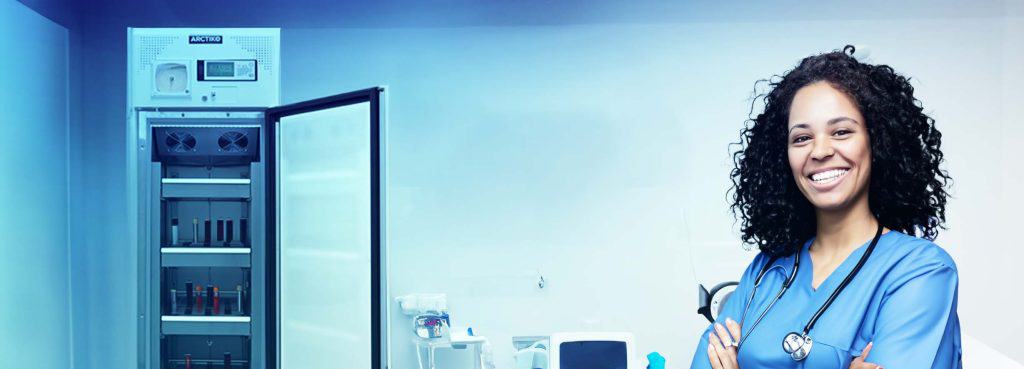 medical lady next to blood bank refrigerator - blood storage